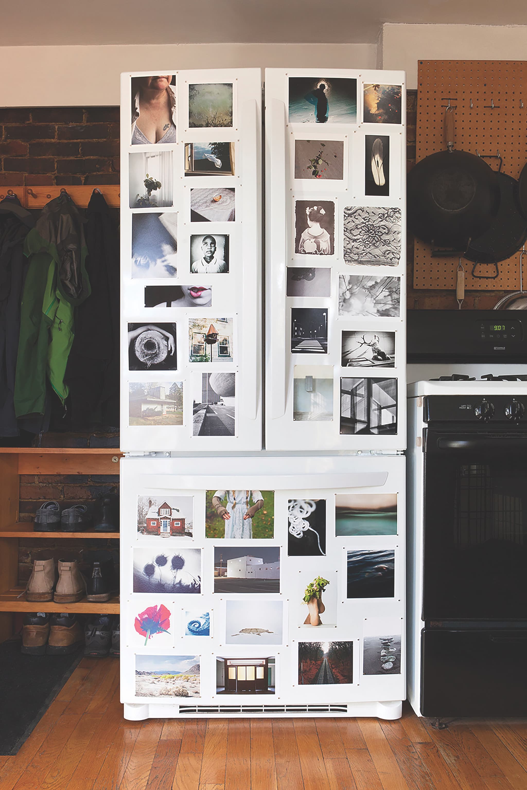 Photographs by Yorgos Efthymiadis appear on a white refrigerator.