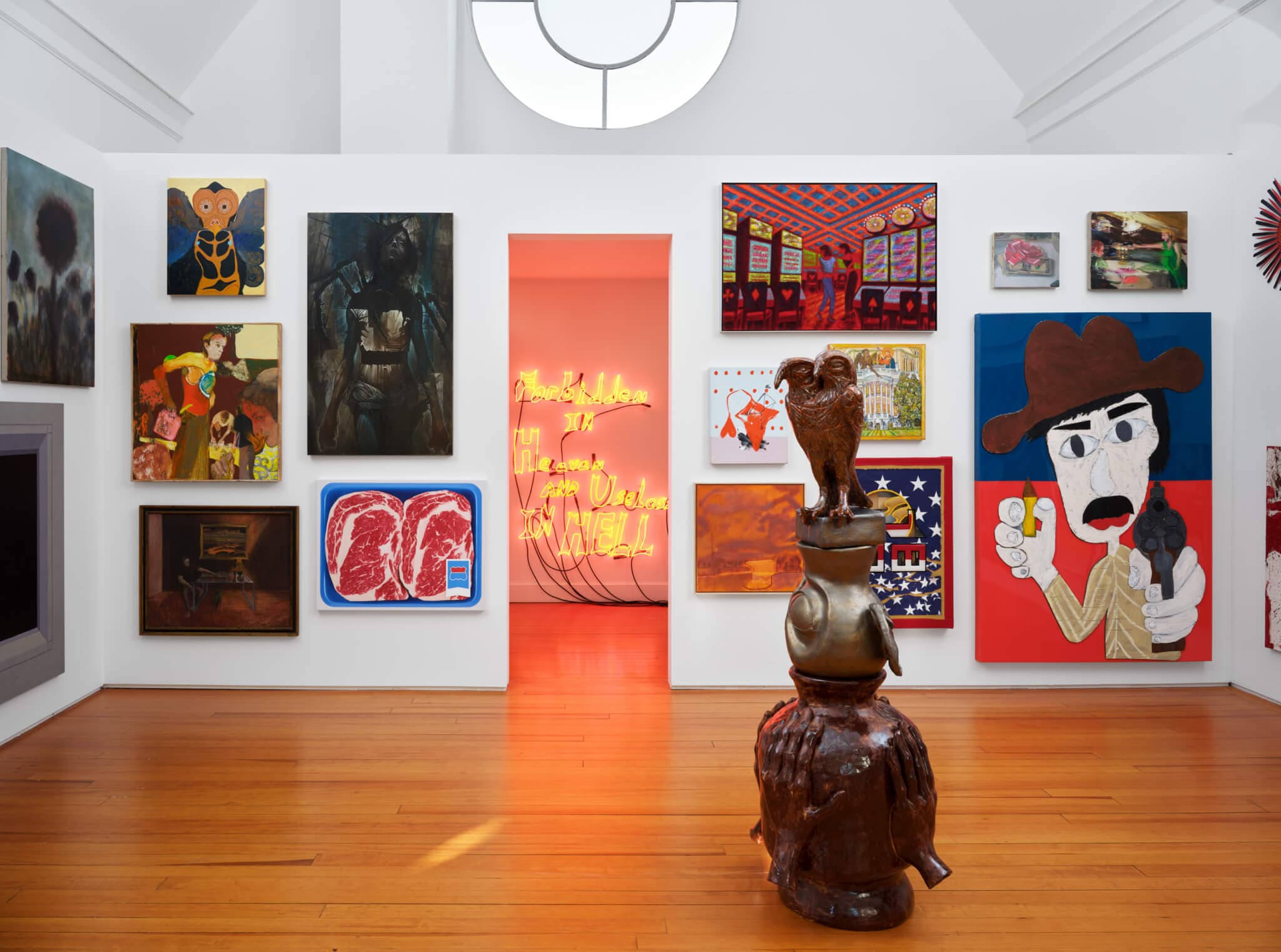 A gallery space features fiery imagery, a neon sign, and a ceramic sculpture.